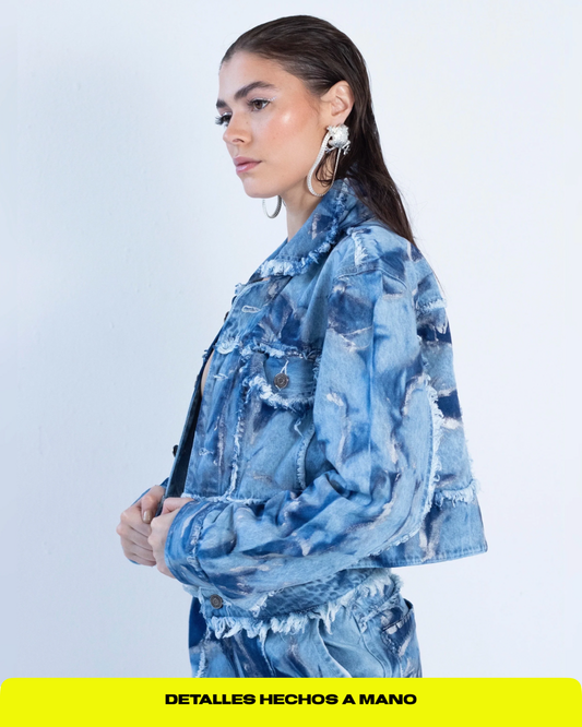 Chaqueta en denim claro con tie dye en azul oscuro y detalles plateados.